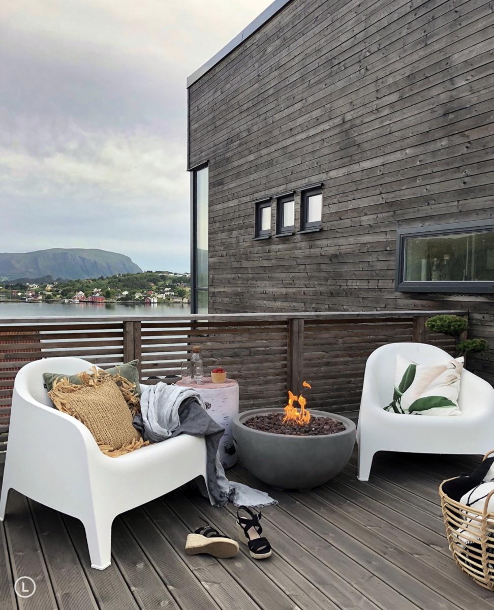 NANTUCKET fire pit with a lit fire on a wooden deck