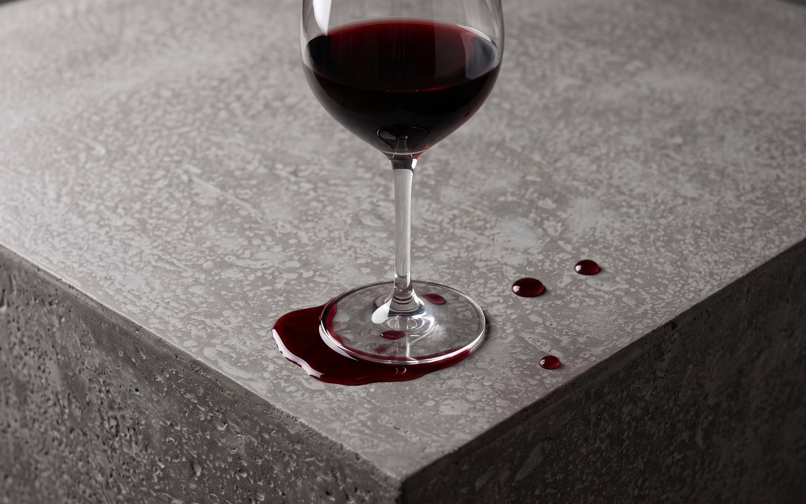 Drops of red wine on a concrete surface