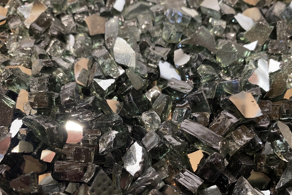 Black fire glass with mirrored pieces up close