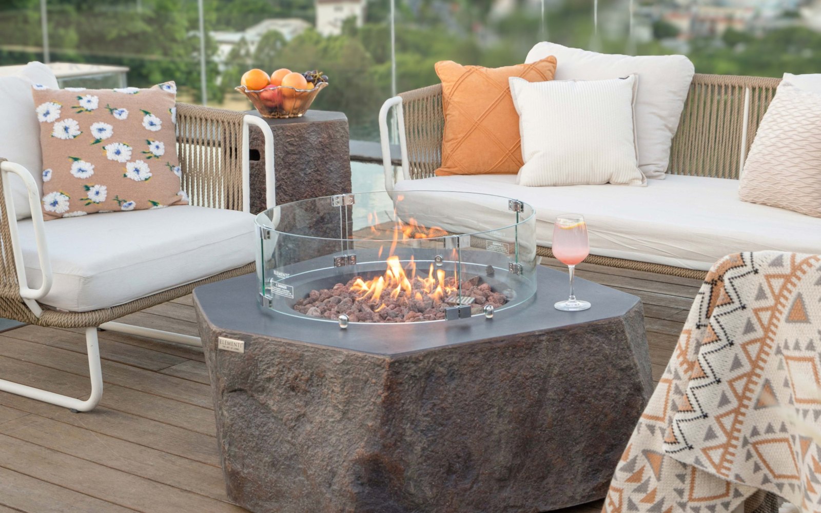 Stone-look bottle cover next to the COLUMBIA fire pit on a terrace
