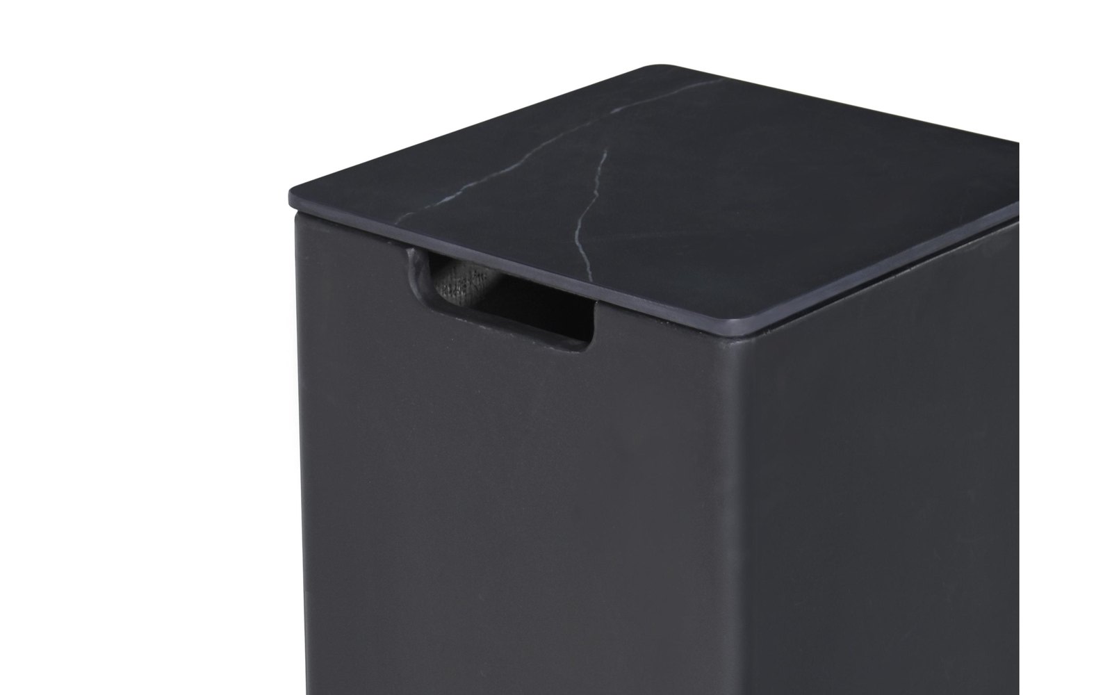 The black ceramic lid of the bottle cover up close
