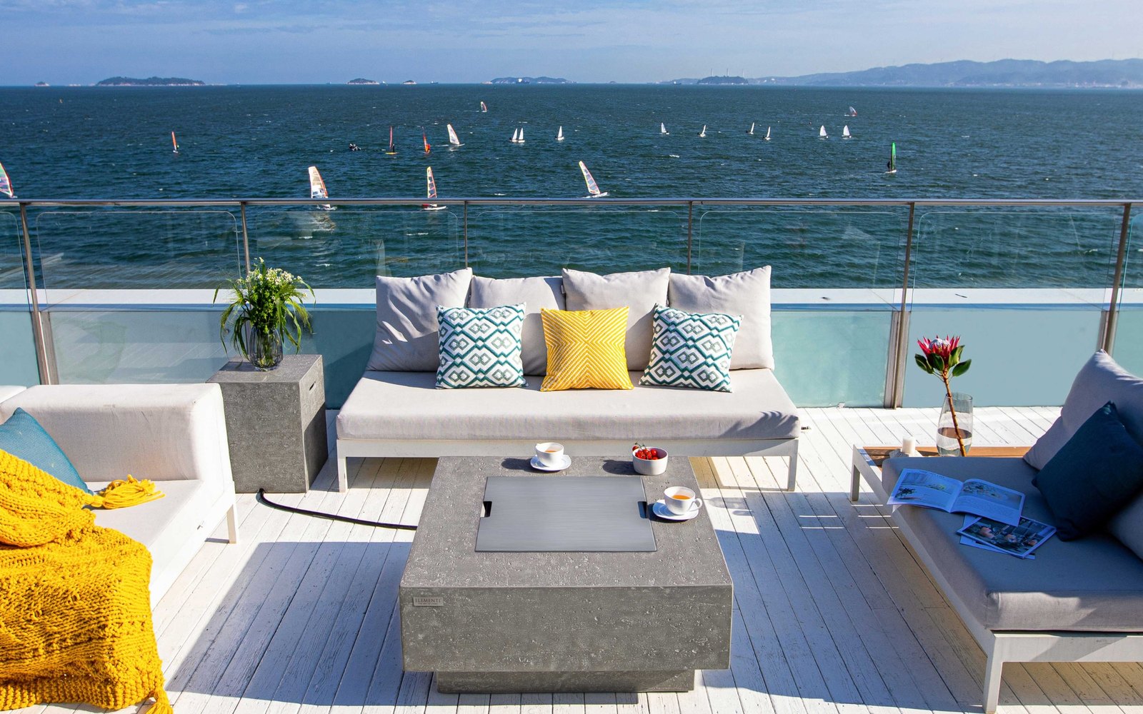 MANHATTAN fire pit with the stainless steel lid on a seaside terrace