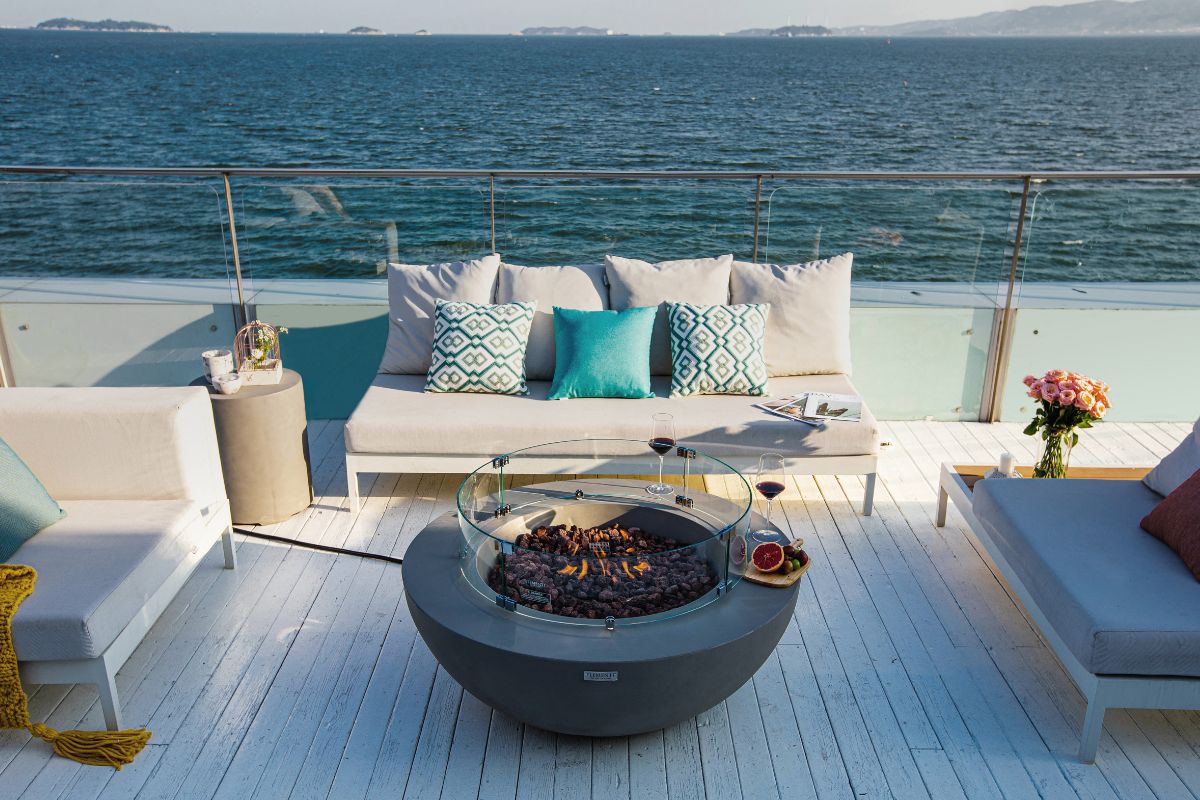 LUNAR BOWL fire pit on a terrace overlooking the sea