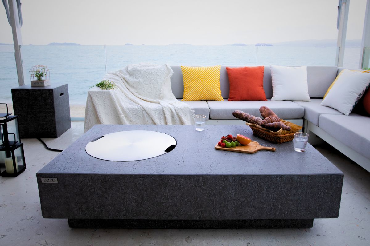 METROPOLIS table with the fire pit lid and bottle cover on a terrace