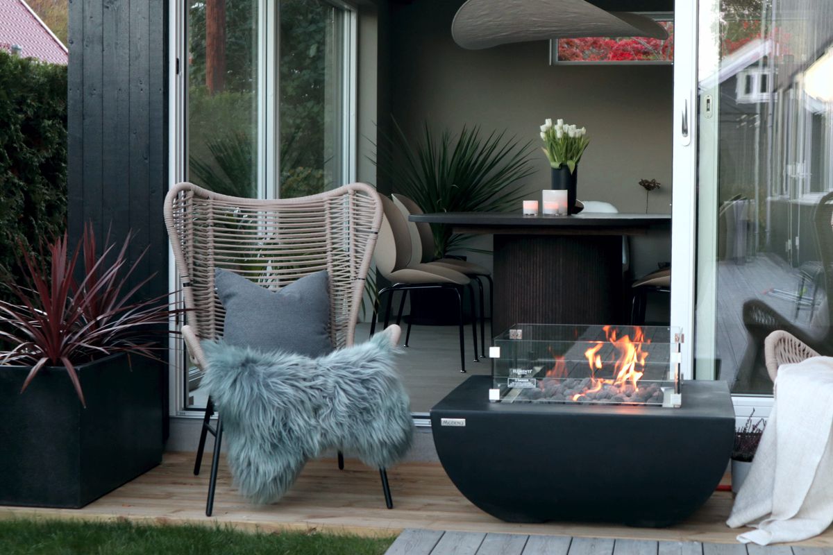AURORA table on a terrace next to a seating area