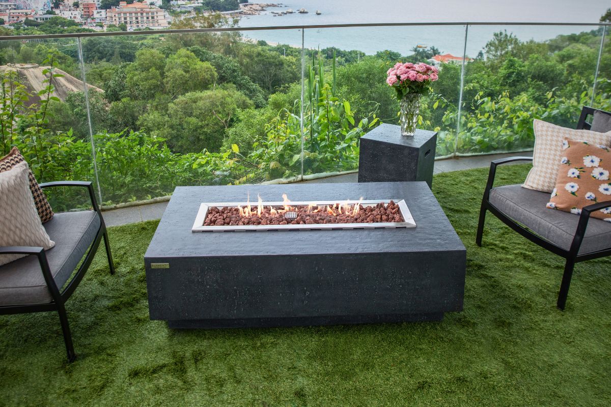 KINGSALE Dark Grey table with a lit fire pit in the garden