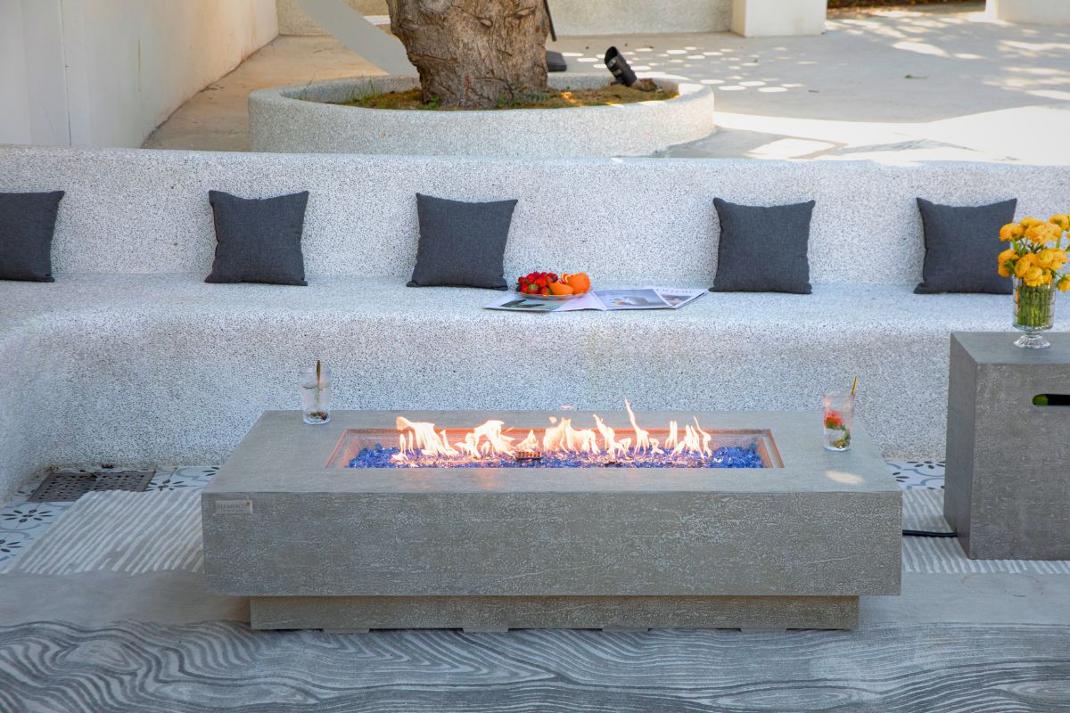 RIVIERA table with a lit fire in front of a lounge sofa