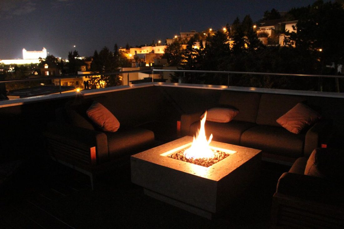MANHATTAN table with a burning fire pit on a terrace